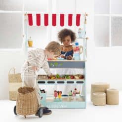 Le Toy Van Shop & Cafe is a reversible two in one wooden toy, offering the best of both worlds, a Cafe on one side, rotate it and you have a Market Stall on the other.